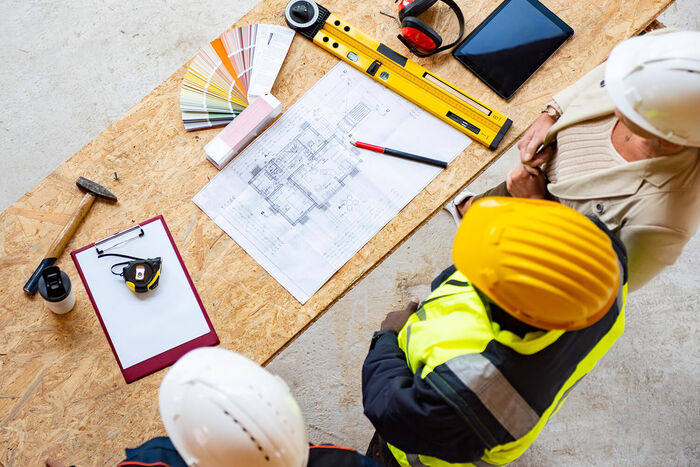 Construction workers planning to install wiring for electronics setup